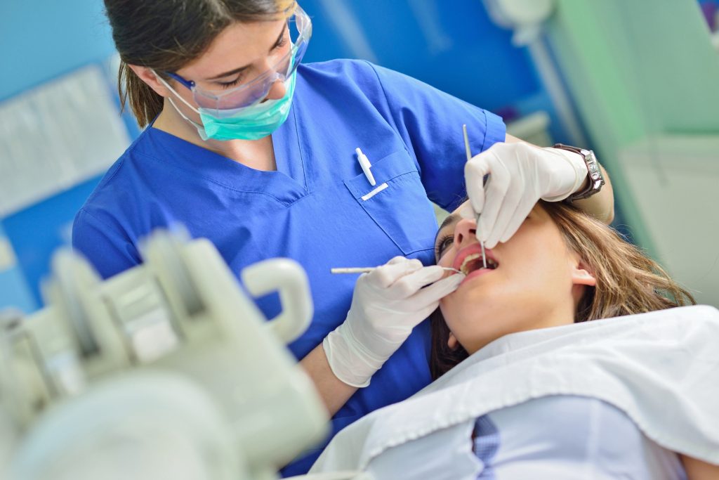 People, Medicine, Stomatology And Health Care Concept Happy Female Dentist Checking Patient Girl Teeth